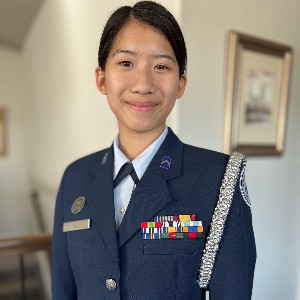 Female student, smiling for the camera in uniform